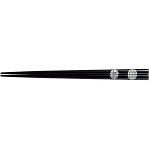 A pair of lacquered chopsticks, a pair of lacquered chopsticks, a large wheel